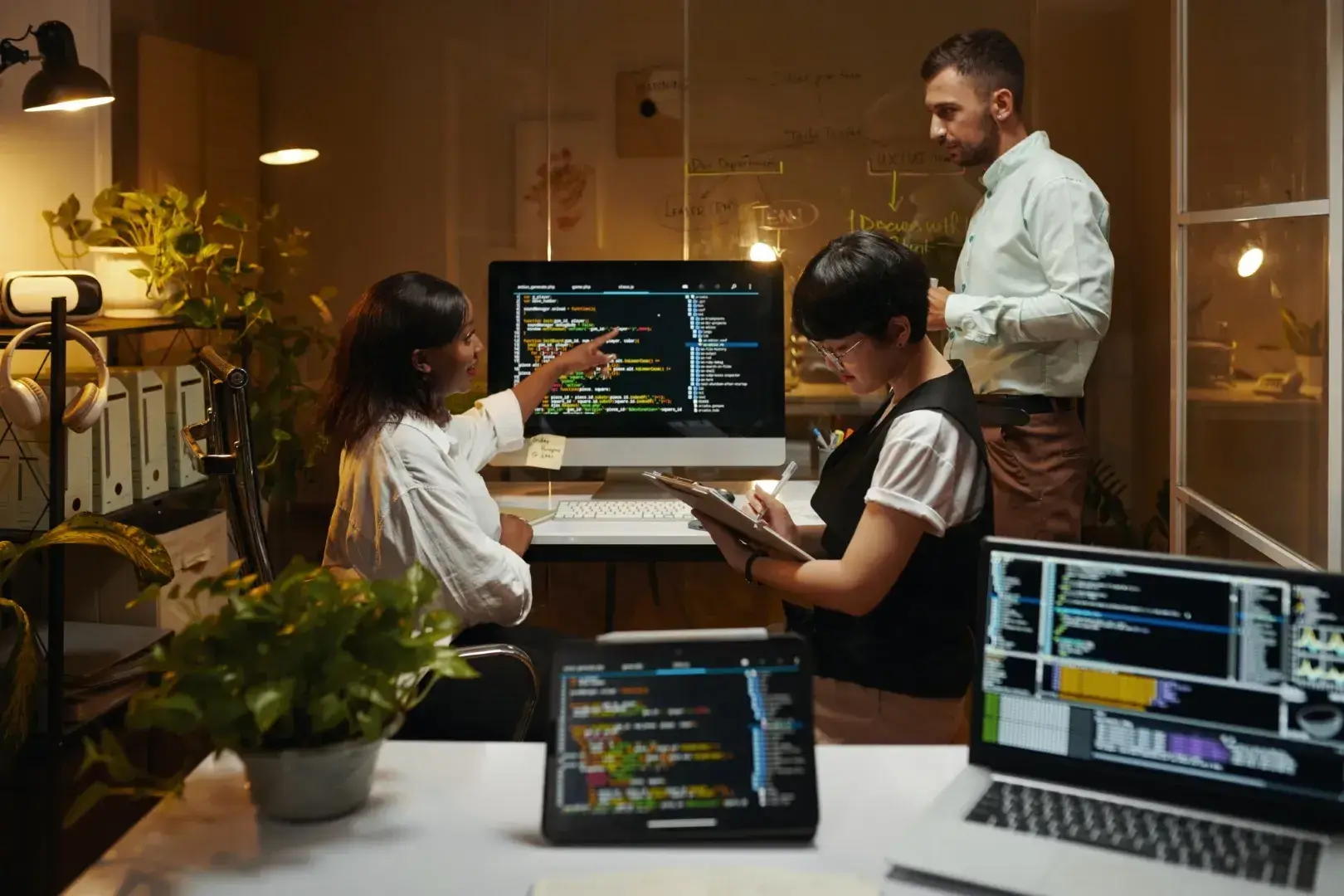 Two developers working through code together at a desk.